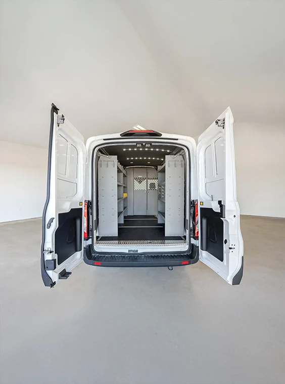 White upfitted van parked inside a clean garage