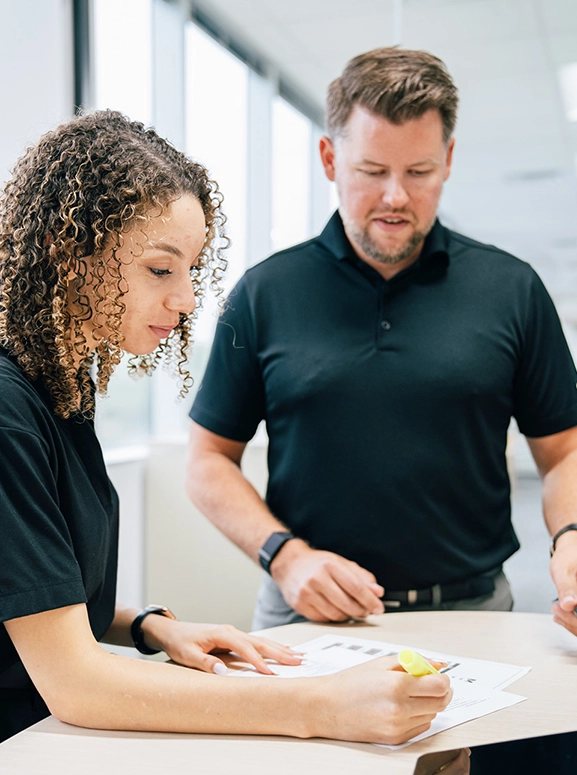woman and man looking at forms for renting a vehicle in New Orleans